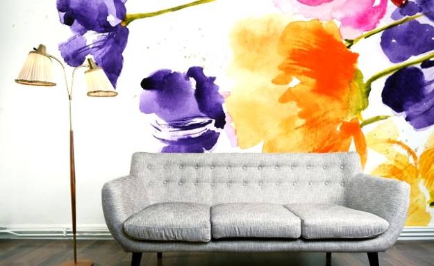 A living room with watercolor flowers on the wall.