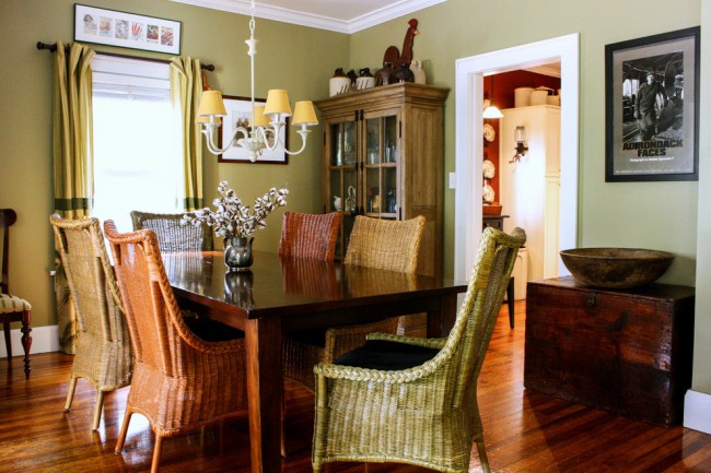 A dining room with rattan table and chairs for an indoor space.