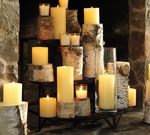 A cozy fireplace decorated with candles.