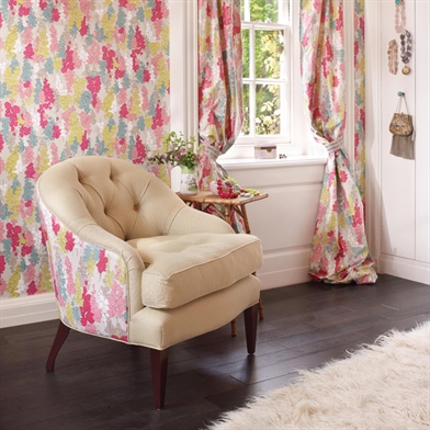 Painterly fabric and wallpaper infuses summer into the room