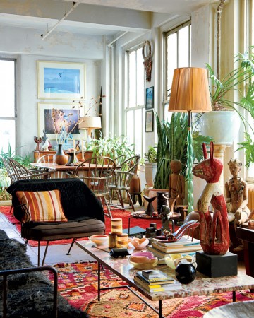 A stylish living room filled with furniture and plants.