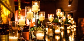 A group of candles gives a warm glow at the table