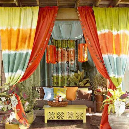A colorful patio with vibrant curtains and furniture.
