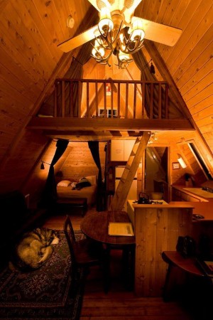 A splendid attic room with a bed and a ceiling fan.