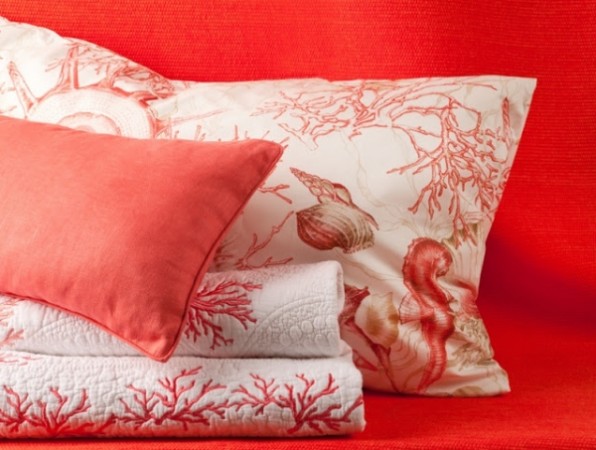 Red coral linens accent the bedroom 
