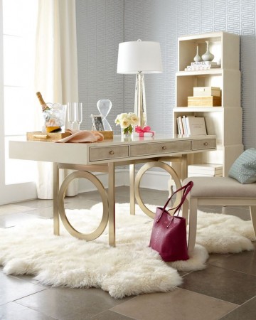 Home office design tip for her: A stylish white desk adorned with a luxurious fur rug and complemented by a bottle of wine.