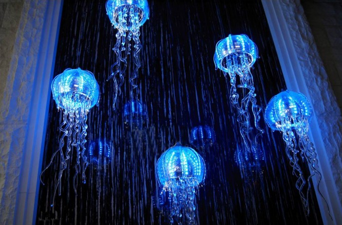 A group of blue jellyfish hanging from the ceiling, offering ocean accents to your home.