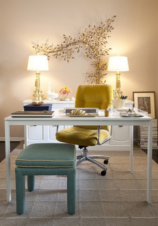 A yellow desk and blue chair add personality to a home office design for her.
