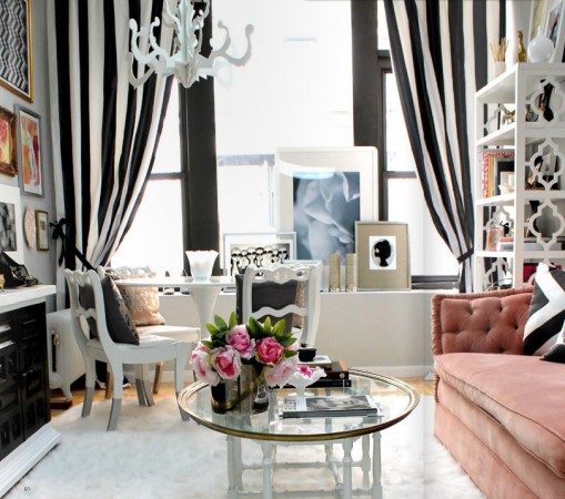 A home office with black and white striped curtains.