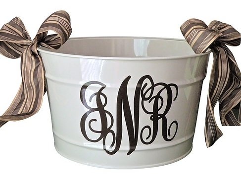A personalized monogram adds a personal touch to a white bucket.