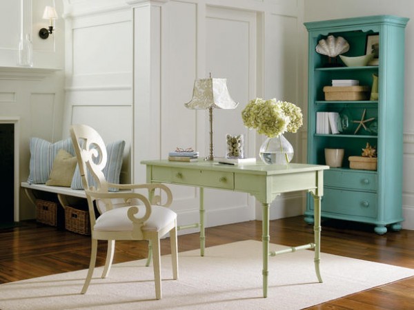 A green desk and chair in a stylish home office.