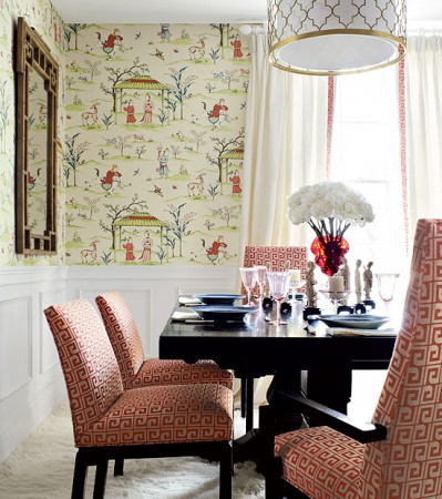 Greek Key upholstered dining room chairs blend nicely with the wallpaper 