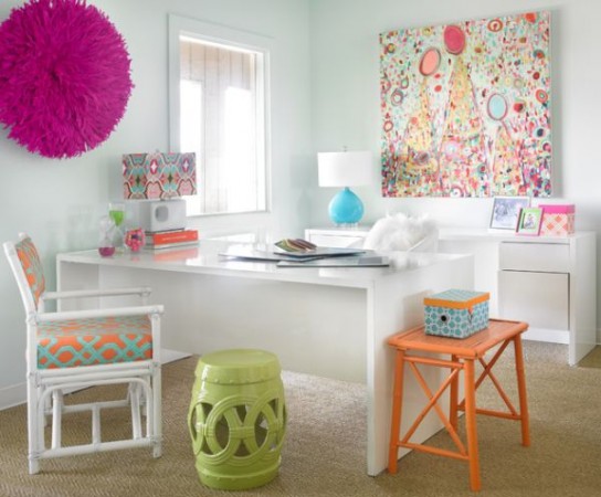 A feminine office space personalized with artwork and colorful accents