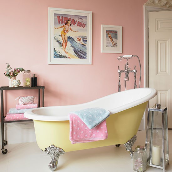 How To Create The Perfect Pastel Bathroom with pink walls and a yellow bathtub.