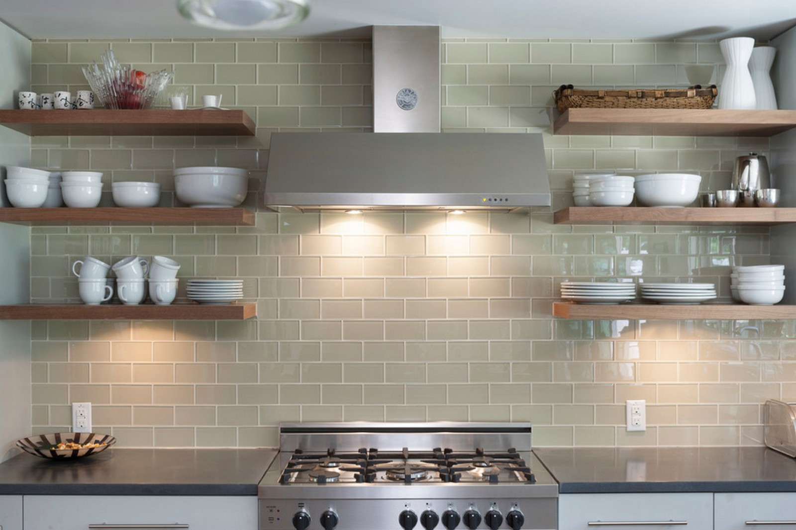 Open shelving in the kitchen with a stove.