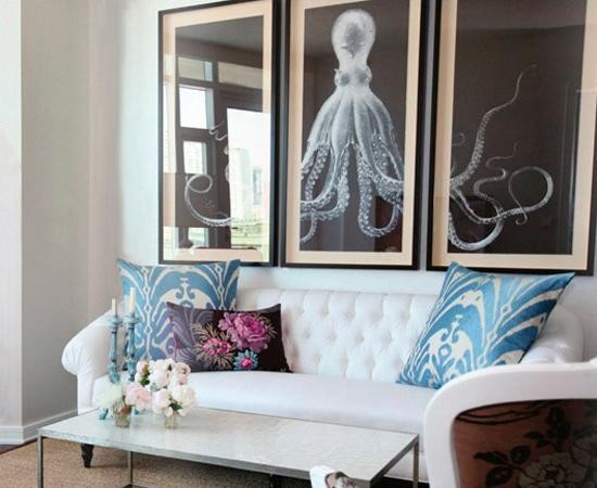 A living room with ocean accents and octopus framed art.
