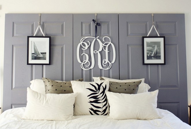A personalized bed with a monogram on the headboard.