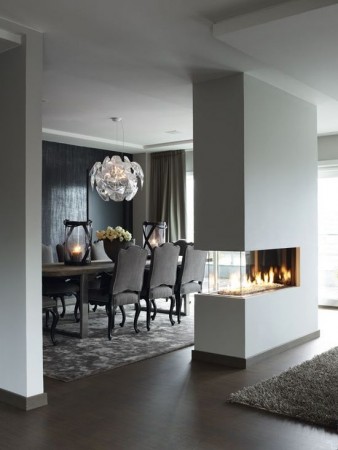 A modern living room with a fireplace, making the most out of its functionality.