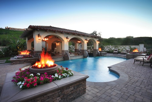 A pool with fire pits and patio furniture in Homes In Paradise.