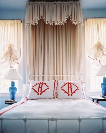 A personalized bed featuring red and white monograms.