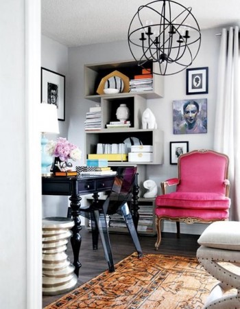 A home office with a pink chair and a rug designed for her.