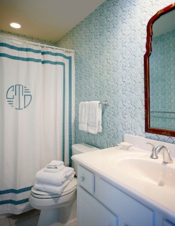A monogrammed bathroom with a blue and white color scheme.