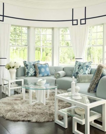 A living room with a blue couch featuring Greek Key Design in Interiors.
