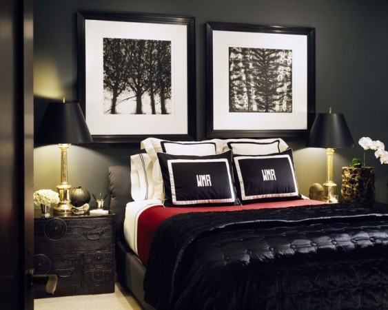 A black and red bedroom with two framed pictures personalized with monograms.