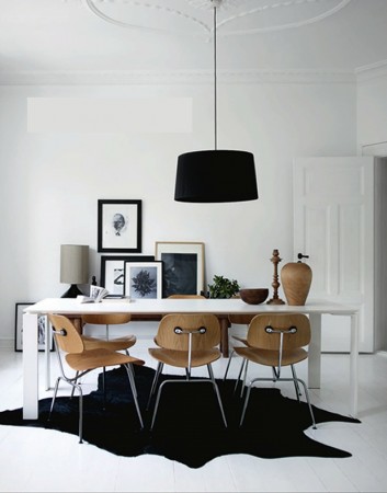 The addition of curbed wooden chairs softens the lines and contrast of the room (pinterest.com)