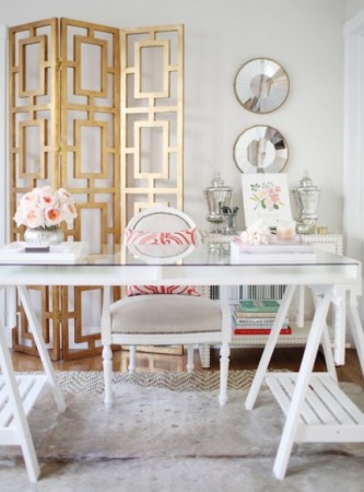 A stylish home office design for her, featuring a white and gold color scheme and including a desk and chairs.