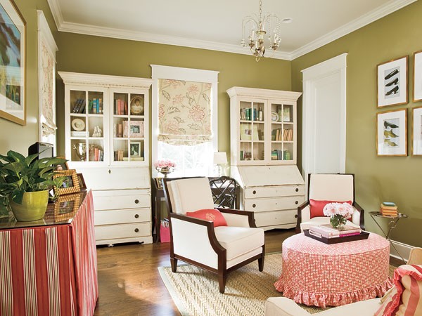 White painted cabinets and bright fabrics add style and elegance to the feminine office