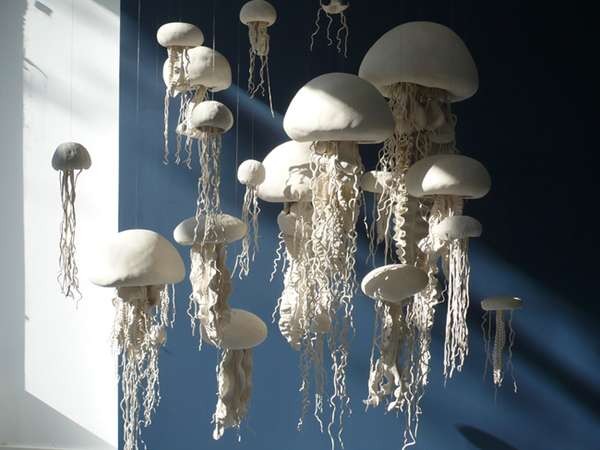 White jellyfish hanging from a blue wall, featuring ocean accents.