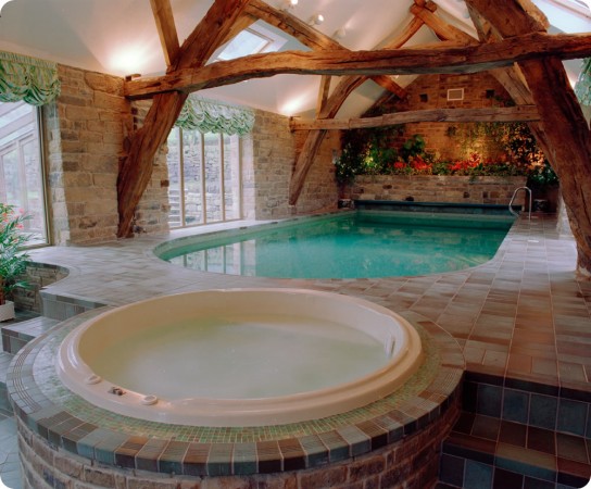 An inspiring indoor oasis featuring a hot tub in the middle of a room.