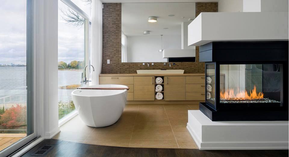 A modern bathroom with a fireplace and tub showcasing opulence and elegance.