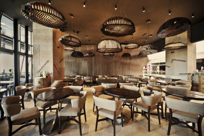 Brown tones add a touch of warmth to this coffee shop design (www.archdaily.com)