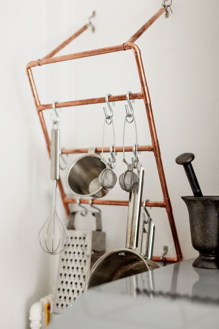 Copper pipes are cleverly connected to form a pot rack (aseptemberfeeling.blogspot.co.uk)