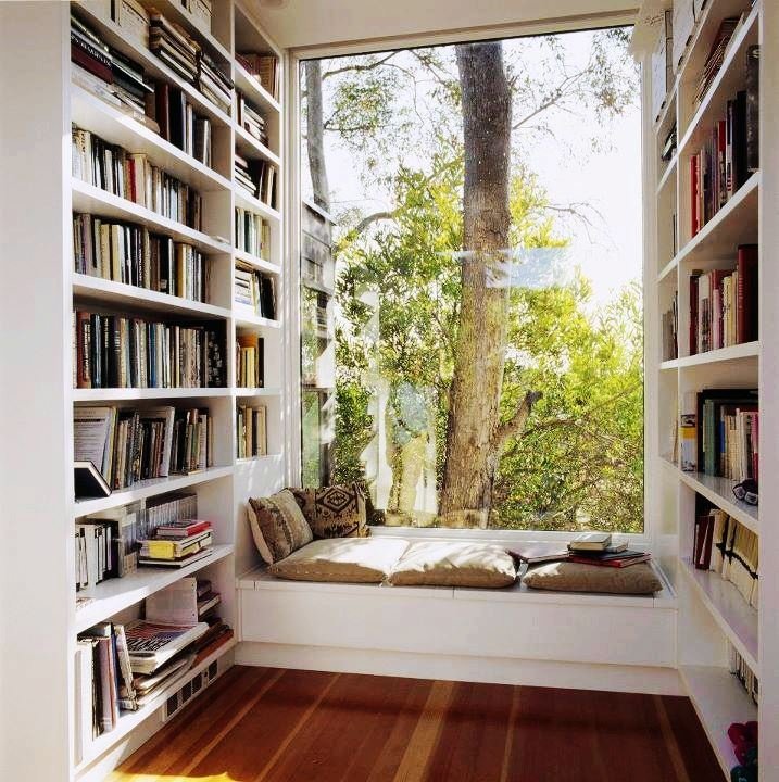 A cozy retreat adorned with bookshelves and a window.