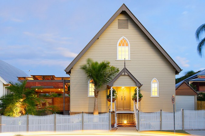 An unconventional church conversion is lit up at dusk, worth conversation.