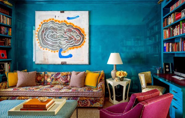 Bright turquoise walls with colorful accents make this room pop 
