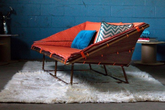 An orange lounge chair on top of a rug.