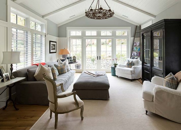 A living room with modern farmhouse style featuring gray walls and white furniture.