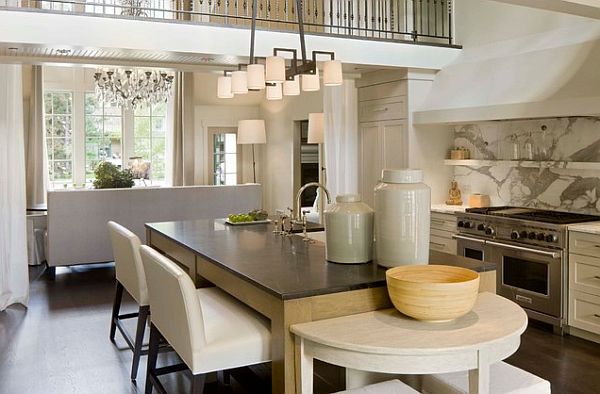 A kitchen with a large island and a farmhouse chandelier.