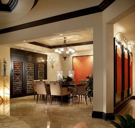 A formal dining room with a wine cellar featuring marble accents.