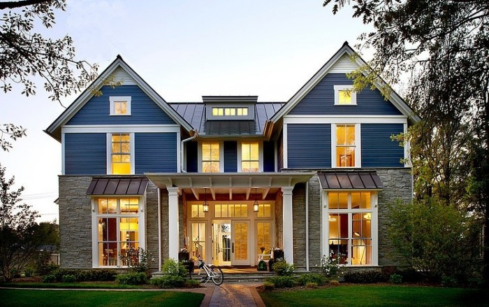A modern farmhouse style house with a large front porch.