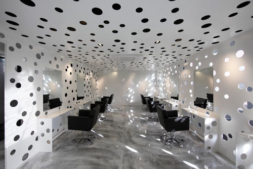 Beauty salon with perforated walls and ceiling