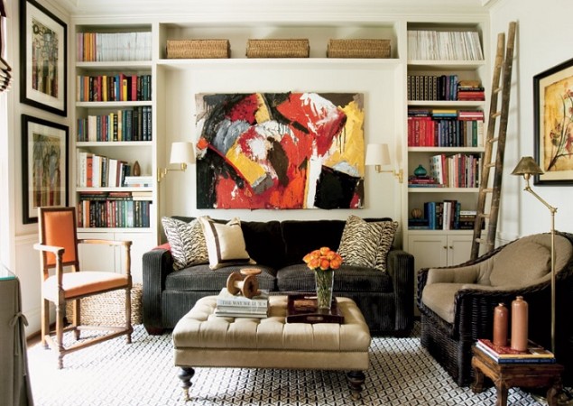 A cozy living room with lots of bookshelves that brings warmth to the house.