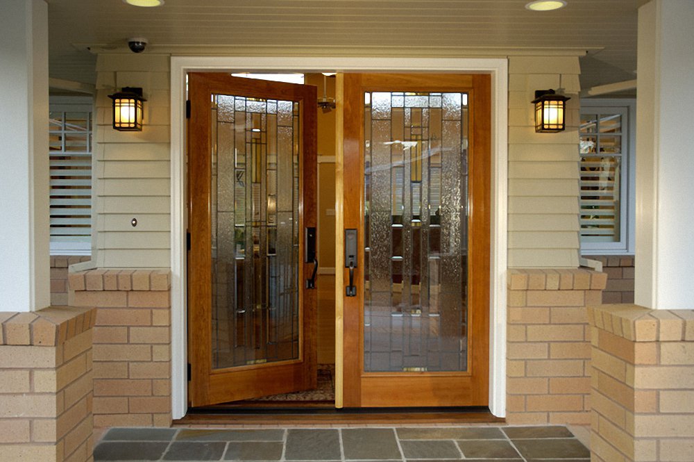 A wooden front entrance door with a glass panel enhancing curb appeal.