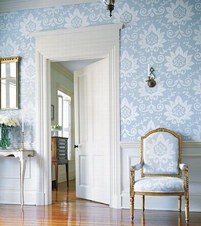 A hallway featuring a vibrant blue and white wallpaper.