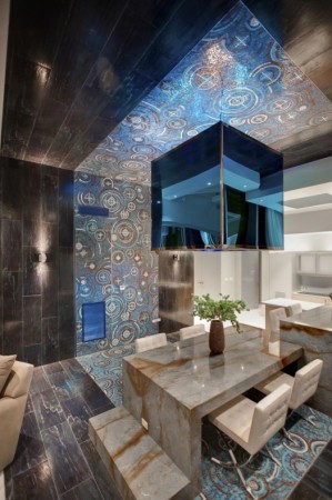 A modern dining room with a blue tiled ceiling featuring marble accents.