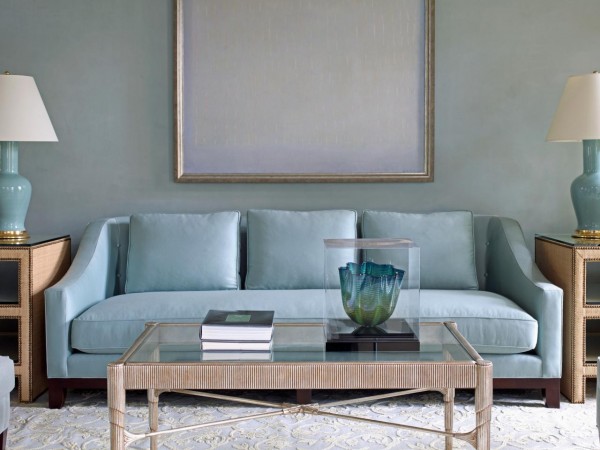 Soft blue sofa blends seamlessly with pale blue walls 